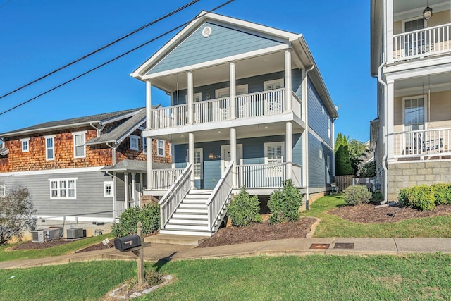 coastal home with central air condition unit and a front lawn