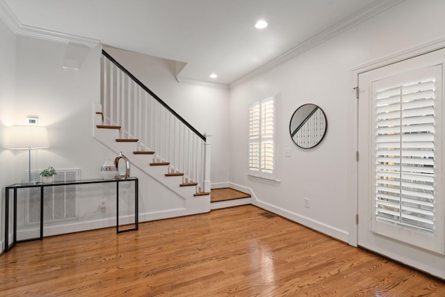 foyer featuring light hardwood / wood-style floors and crown molding