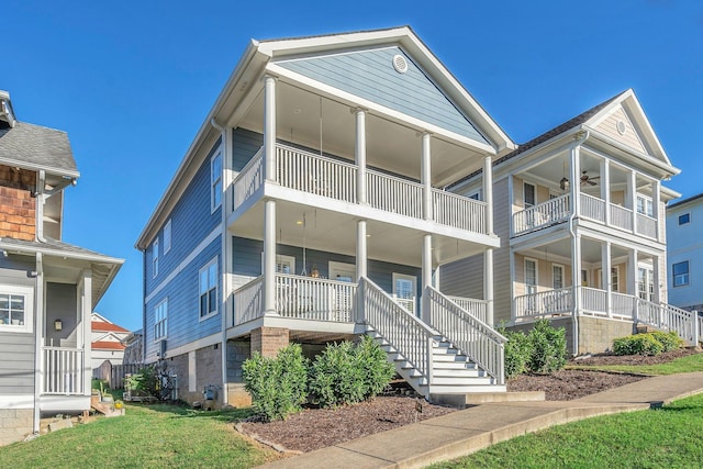 view of front of home featuring a front yard, covered porch, and a balcony