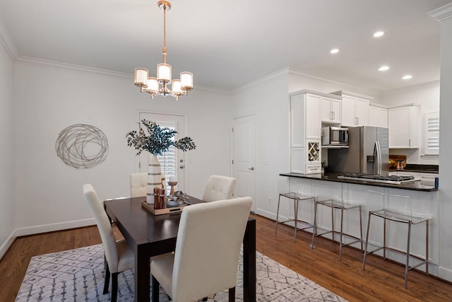 dining space with a notable chandelier, crown molding, and dark hardwood / wood-style floors