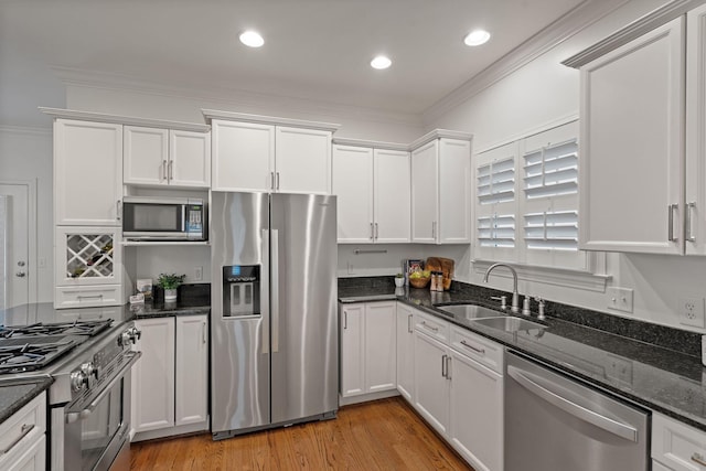 kitchen featuring appliances with stainless steel finishes, white cabinetry, and sink