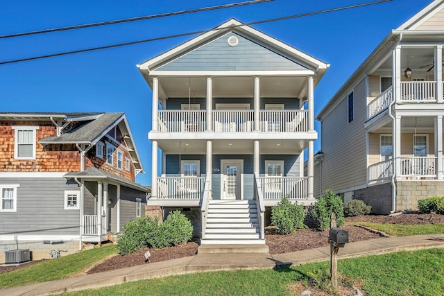 coastal inspired home with cooling unit and covered porch