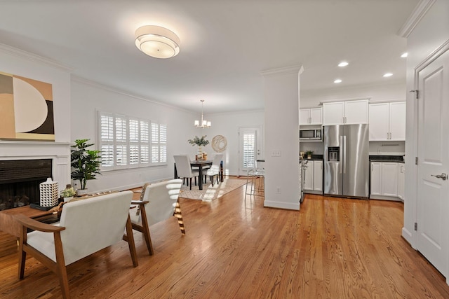 kitchen featuring white cabinetry, crown molding, and appliances with stainless steel finishes