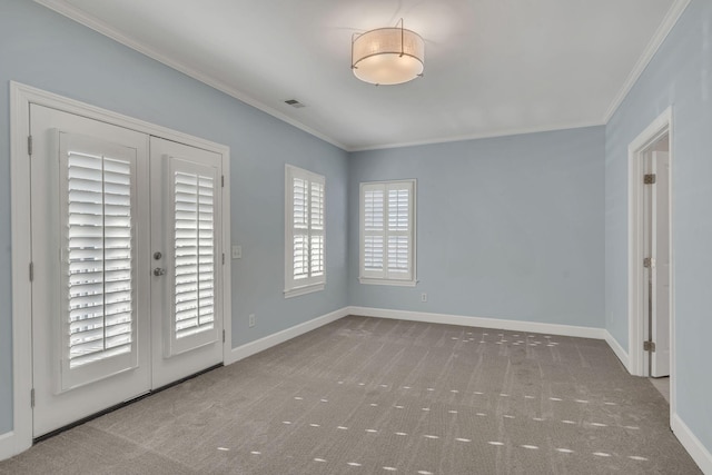 empty room with french doors, ornamental molding, and light carpet