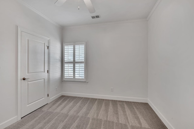 carpeted empty room featuring ornamental molding and ceiling fan