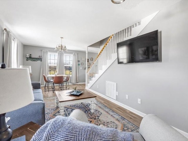 living room with a chandelier and hardwood / wood-style flooring