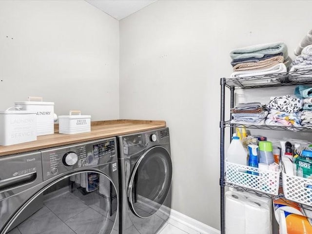 laundry room with washing machine and dryer and tile patterned floors