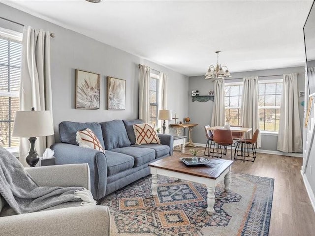 living room with a notable chandelier and hardwood / wood-style flooring