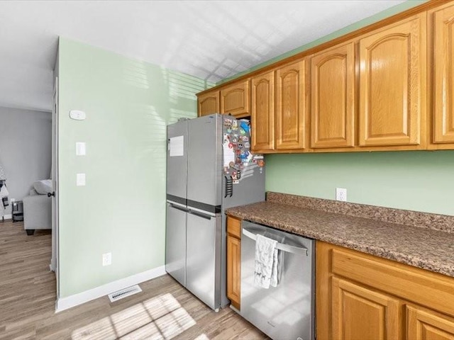 kitchen with stainless steel appliances and light wood-type flooring