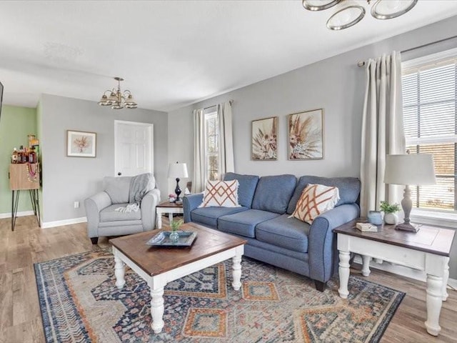 living room featuring an inviting chandelier and light hardwood / wood-style flooring