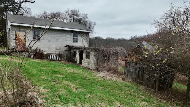 view of side of home with a lawn