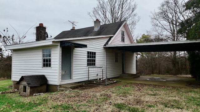 rear view of property with a carport