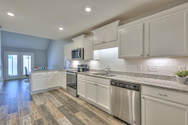 kitchen featuring stainless steel appliances, sink, white cabinets, and kitchen peninsula