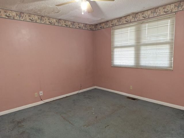 spare room with ceiling fan, a textured ceiling, and carpet flooring