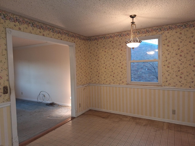 unfurnished dining area featuring a textured ceiling