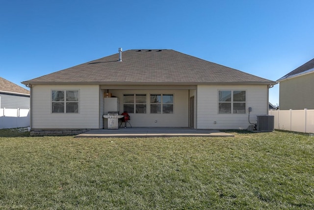 rear view of property featuring central AC unit, a lawn, and a patio