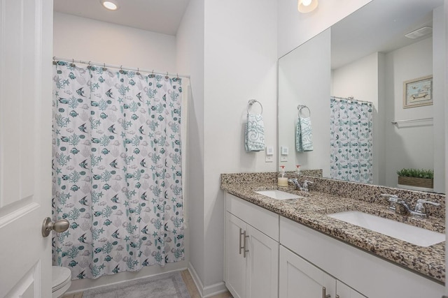 bathroom featuring toilet and vanity