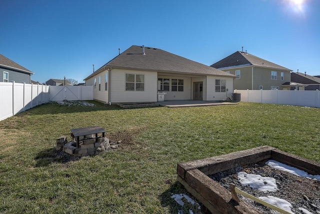 back of house featuring a yard, a fire pit, and a patio