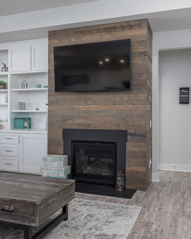 interior details featuring a large fireplace and hardwood / wood-style floors