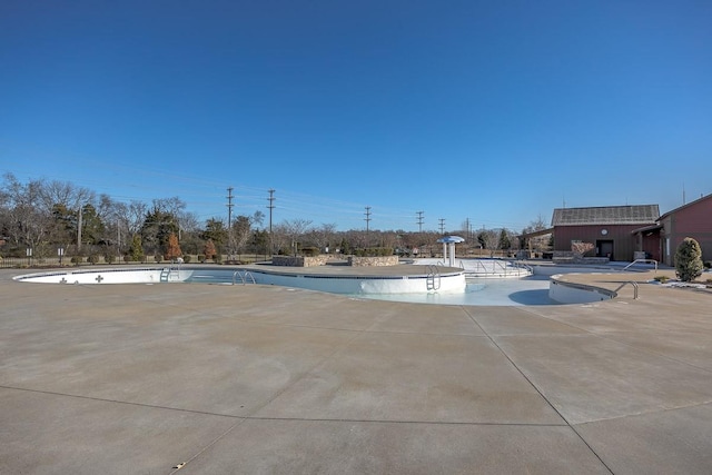 view of swimming pool with a patio