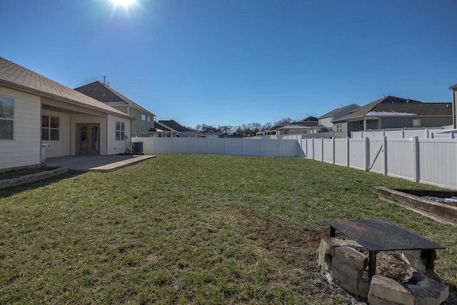 view of yard with central AC unit, french doors, and a patio area