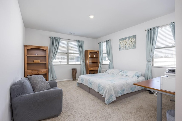 bedroom with multiple windows and carpet flooring