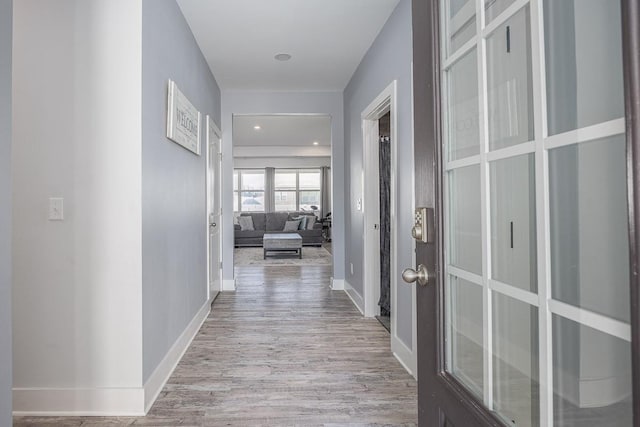 hall with light hardwood / wood-style flooring