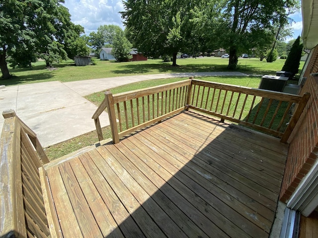 wooden deck with a patio area and a lawn