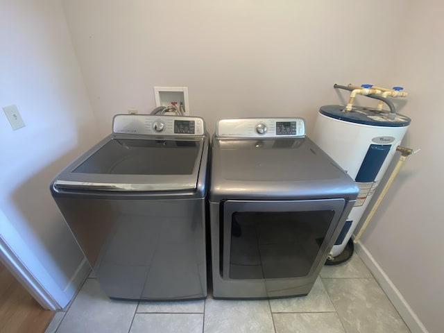 washroom featuring light tile patterned floors and washer and clothes dryer