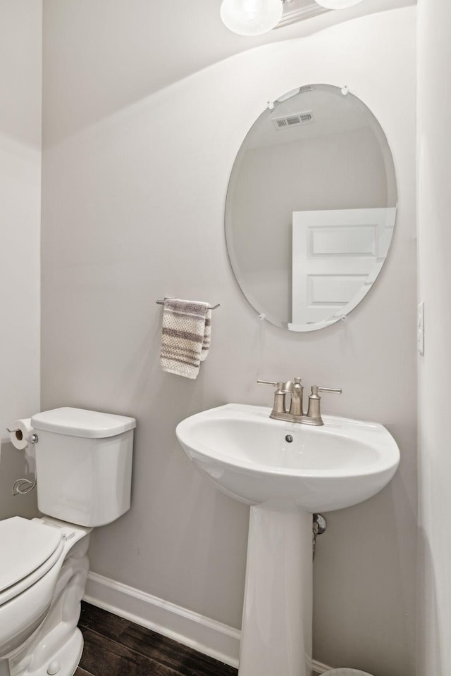 bathroom with sink, hardwood / wood-style floors, and toilet