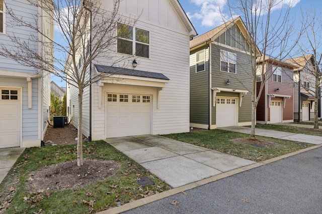 view of front facade featuring central AC unit and a garage