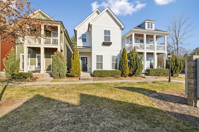 view of front of house with a balcony and a front yard