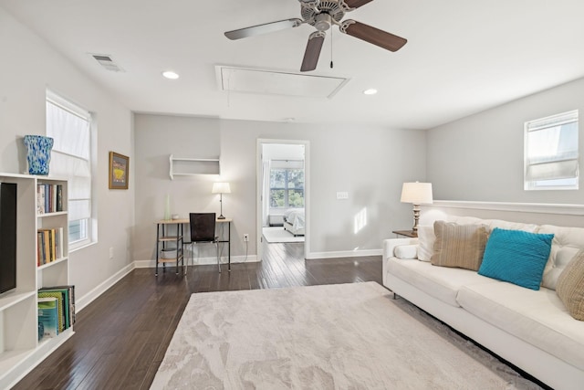 living room with ceiling fan and dark hardwood / wood-style flooring