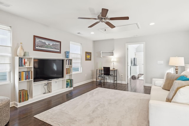 living room featuring dark wood-type flooring, plenty of natural light, and ceiling fan