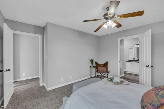 carpeted bedroom with ceiling fan and ensuite bath