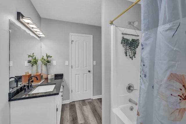 bathroom featuring shower / bath combination with curtain, wood-type flooring, and vanity