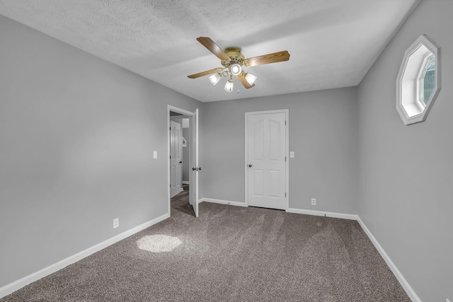 unfurnished room featuring ceiling fan, a textured ceiling, and carpet flooring