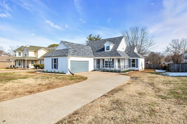 cape cod home featuring a garage, a front yard, and a porch