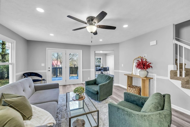 living room with ceiling fan and hardwood / wood-style floors