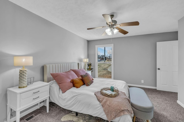 carpeted bedroom featuring a textured ceiling and ceiling fan