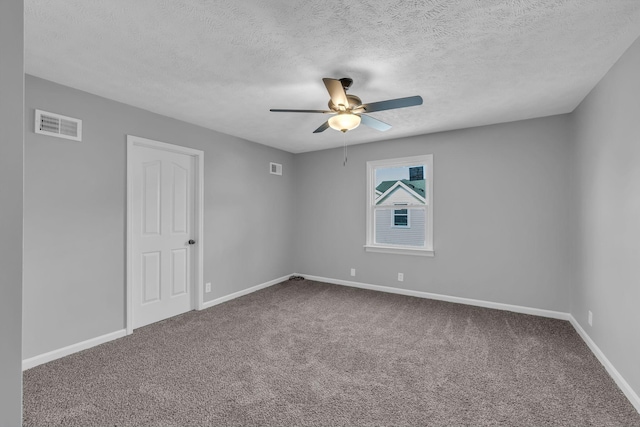 unfurnished room with ceiling fan, a textured ceiling, and carpet flooring