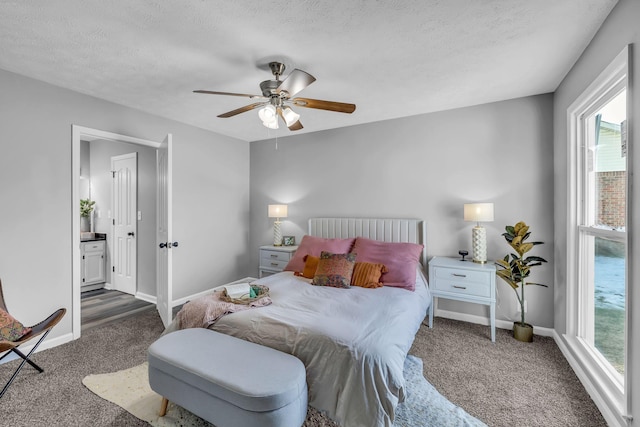 carpeted bedroom with ceiling fan, a textured ceiling, and ensuite bathroom