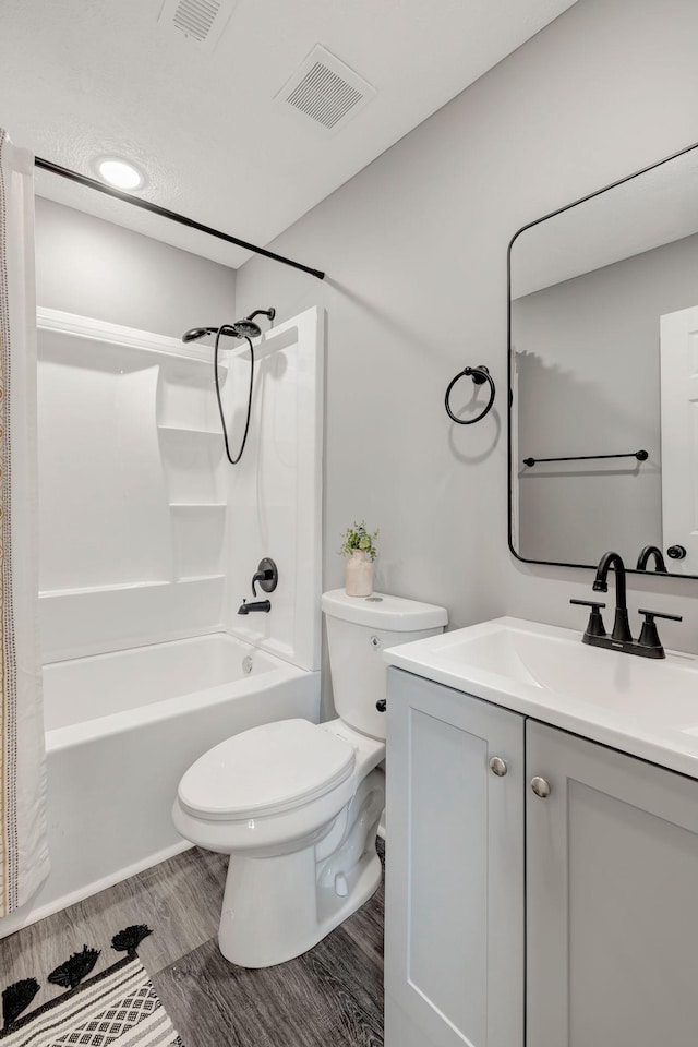 full bathroom featuring toilet, vanity, and shower / bathtub combination with curtain