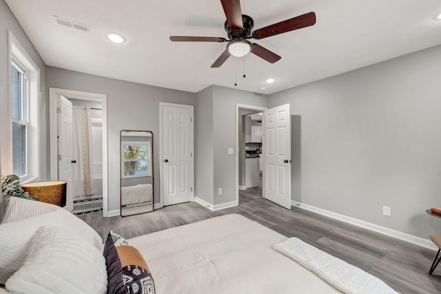 bedroom with ceiling fan and hardwood / wood-style floors