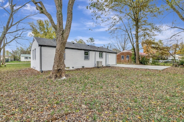 back of house featuring a patio, a lawn, and central air condition unit