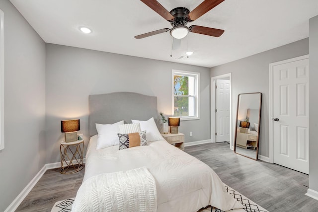 bedroom with ceiling fan and hardwood / wood-style flooring