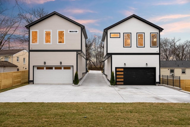 view of front of house featuring an attached garage, a front lawn, and fence