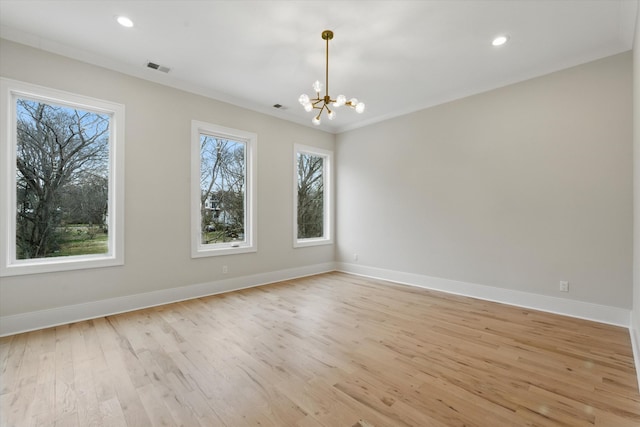 unfurnished room with a chandelier, light wood finished floors, and baseboards