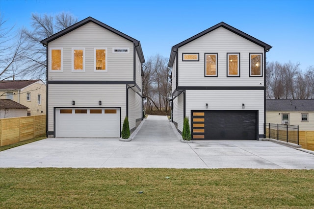 view of front of home featuring an attached garage, concrete driveway, a front lawn, and fence