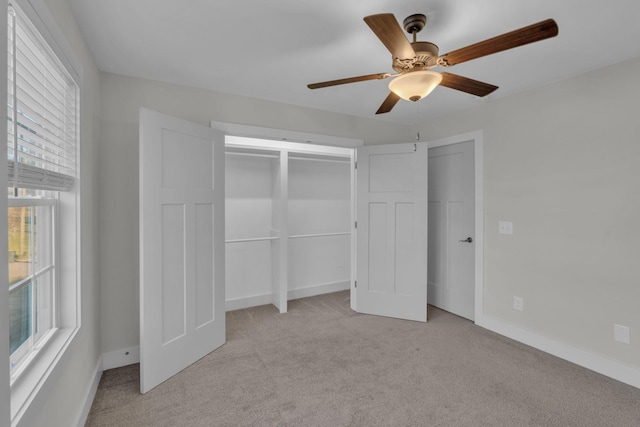 unfurnished bedroom featuring ceiling fan and light carpet